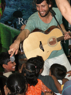 Daniel Tyler Pohnke of Full Moon Rising with the kids of Dharavi